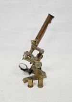Early 20th century brass microscope, together with two lenses in original canisters, the