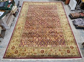 Later 20th century large carpet, the central panel with soft green and yellow-gold repeating