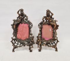 Pair of Late Victorian coppered spelter picture frames, each cast with a scantily draped figure of