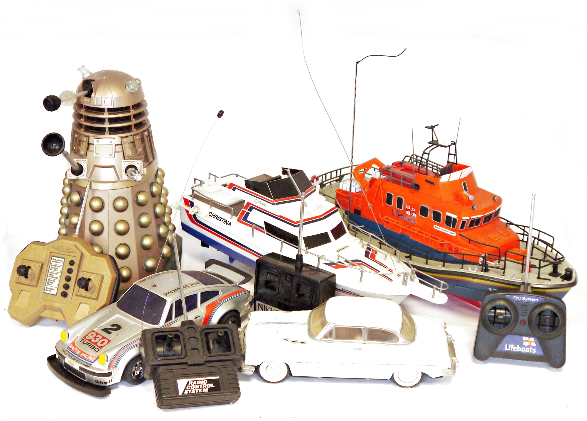 A remoted control model of a lifeboat, a remote control Porsche motor car, and other remoted control
