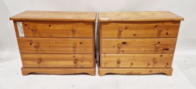 A pair of modern pine chest of drawers each comprising three long drawers with turned pine handles