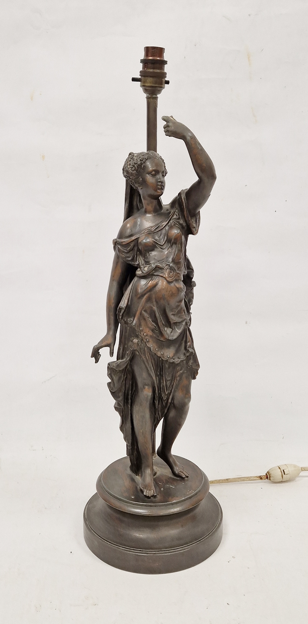 20th century bronzed metal figural table lamp, cast with a scantily-draped woman raising her left