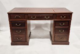 Edwardian mahogany pedestal desk with leather inlet top and an arrangement of nine short drawers