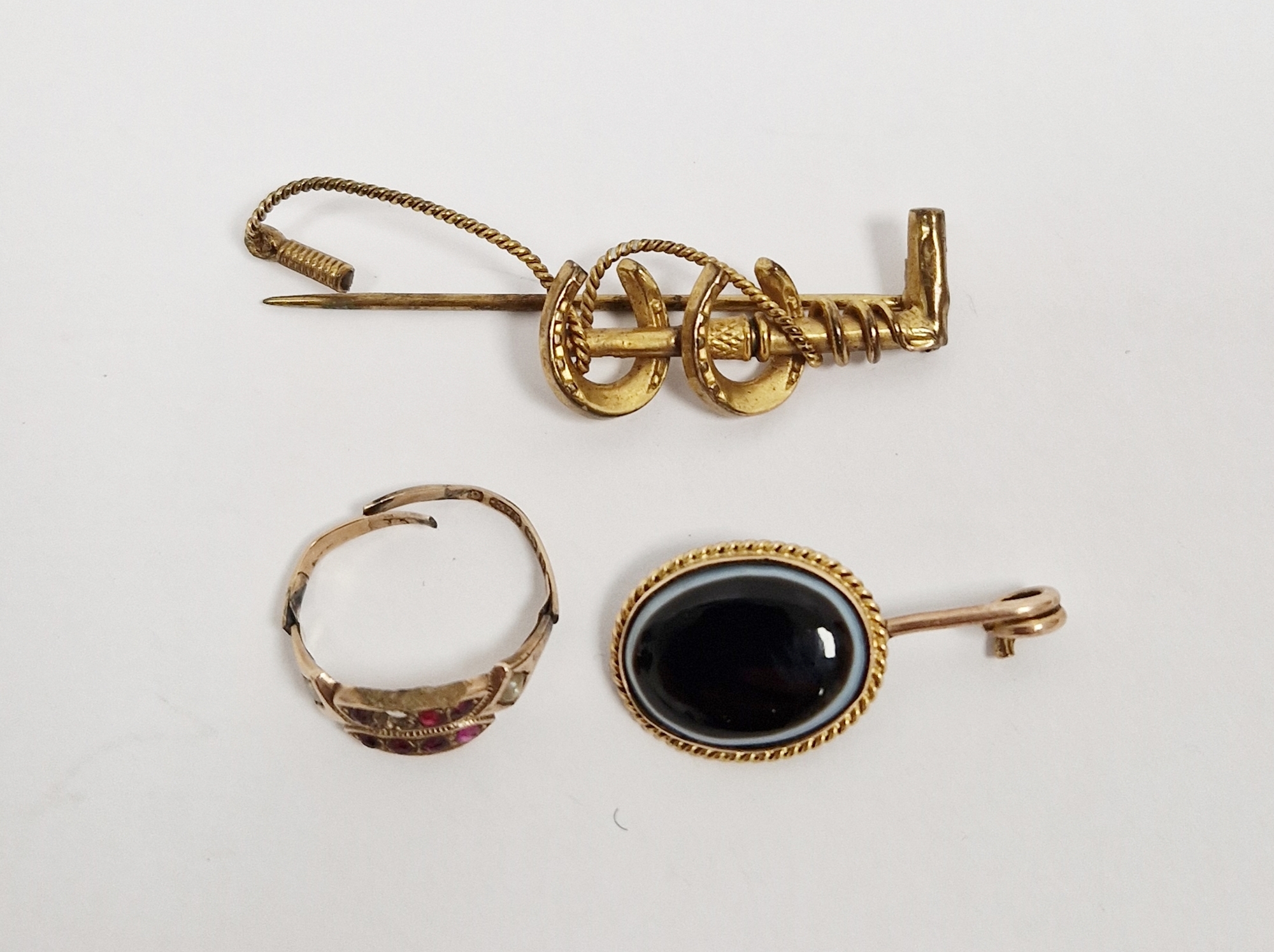 9ct gold bar brooch, horseshoe and crop (damaged), a gold-coloured metal and onyx brooch (