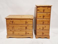 A modern pine chest of drawers comprising three long drawers each with turned wooden handles,