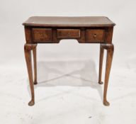 Antique oak lowboy having a central drawer flanked on either side by two short drawers, raised on