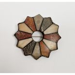 Silver-coloured metal and agate star-shaped brooch set with various panels of coloured agates