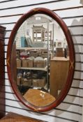 20th century oval wall mirror with moulded mahogany frame and bevelled plate, 82cm x 55cm
