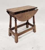 An antique oak drop flap occasional table with turned and carved legs measuring approx 54 cm high
