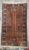 Baluchi brown ground rug, the central panel with tree of life style decoration containing stylised