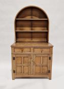 Oak kitchen dresser with an arched two-tier plate rack mounted to the top, the base comprising two