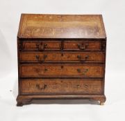 A 19th century oak bureau the full front opening to reveal a selection of fitted drawers,