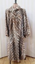 1980s mink coat, batwing sleeves, chevron design in light brown, grey and cream, labelled 'Vizon