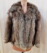 Vintage black/grey fox fur jacket, no label, the inner seam lined with leather, and a small rip of