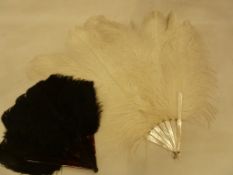 A mother of pearl ostrich feather fan described as a 'debutante's fan' with a black ostrich