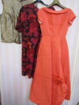 Various vintage 1950s and later dresses to include an orange ribbed satin ball gown stiff petticoat,