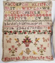 A Georgian sampler named 'Hannah Braithwaite 1825', embroidered with the alphabet, numbers, flowers,