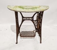 Cast iron treadle base from a sewing machine, but with a half-moon stone top