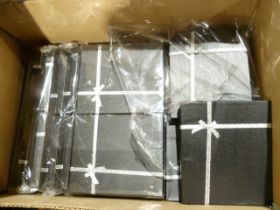 Thirty five sealed packs of four black card jewellery boxes with silver ribbon decoration, each 19 x