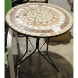 Circular garden table with mosaic inlaid top, on cast iron tripod feet and two matching folding