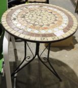 Circular garden table with mosaic inlaid top, on cast iron tripod feet and two matching folding