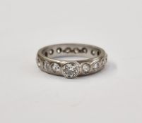 Platinum and diamond ring, set central raised stone, 0.2-0.25 approx, the band set all around with