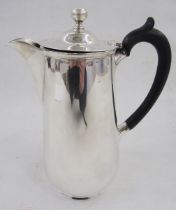 1920s silver hot water jug with ball finial, ebonised scroll handle, tapered on circular foot,