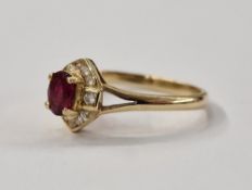 14ct gold ruby and white stone ring, set oval ruby surrounded by small diamonds in elliptical