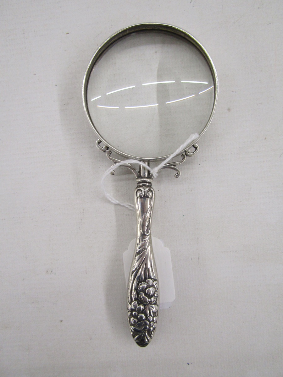 Late 19th/early 20th century silver magnifying glass, with embossed floral motifs adorning the - Image 2 of 2