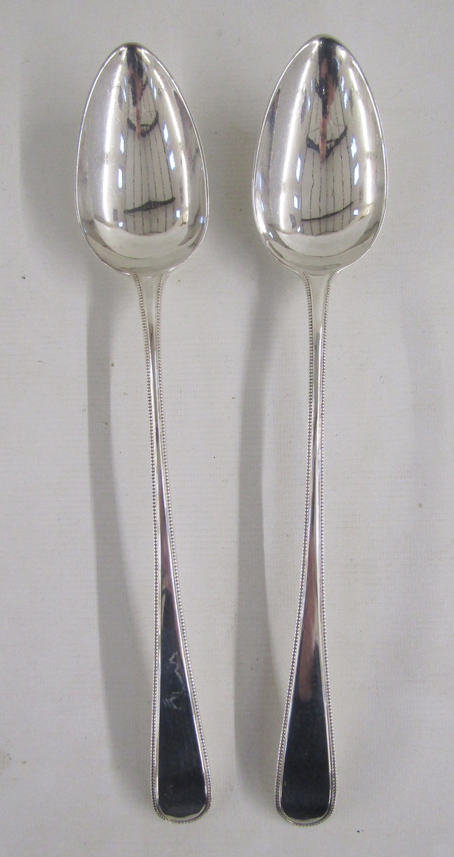 Pair of George III silver gravy/basting spoons, rat tail handles, hallmarked London 1806, by William