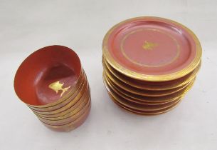 Set of Asian red lacquer tableware, comprising: seven bowls and eight plates, each gilt with a Dog