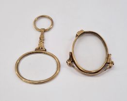 Gold-coloured folding lorgnette and a hand-held gold-coloured looking glass with scroll engraved