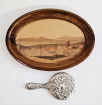 Silver repousse hand mirror from a dressing table set, cast with a rocaille cartouche and flowers,