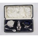 George V Art Deco silver condiment set, comprising lidded mustard, open salt and pepper pot, with
