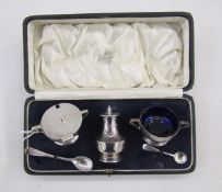 George V Art Deco silver condiment set, comprising lidded mustard, open salt and pepper pot, with