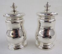 Pair of 20th century silver armorial salt and pepper grinders, each of baluster form, engraved