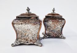 A pair of early Sheffield plate tea caddies, c 1750, with embossed foliate design, on four ball