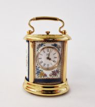 Halcyon Days gilt-metal mounted and enamelled miniature carriage clock, of oval form with swing