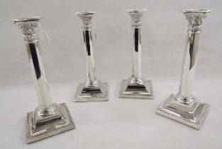 Set of four early 20th century Georgian style silver candlesticks, of Corinthian column form, raised