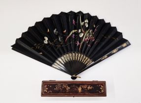 19th century Canton black lacquer and painted paper fan in lacquered box, painted with flowers,