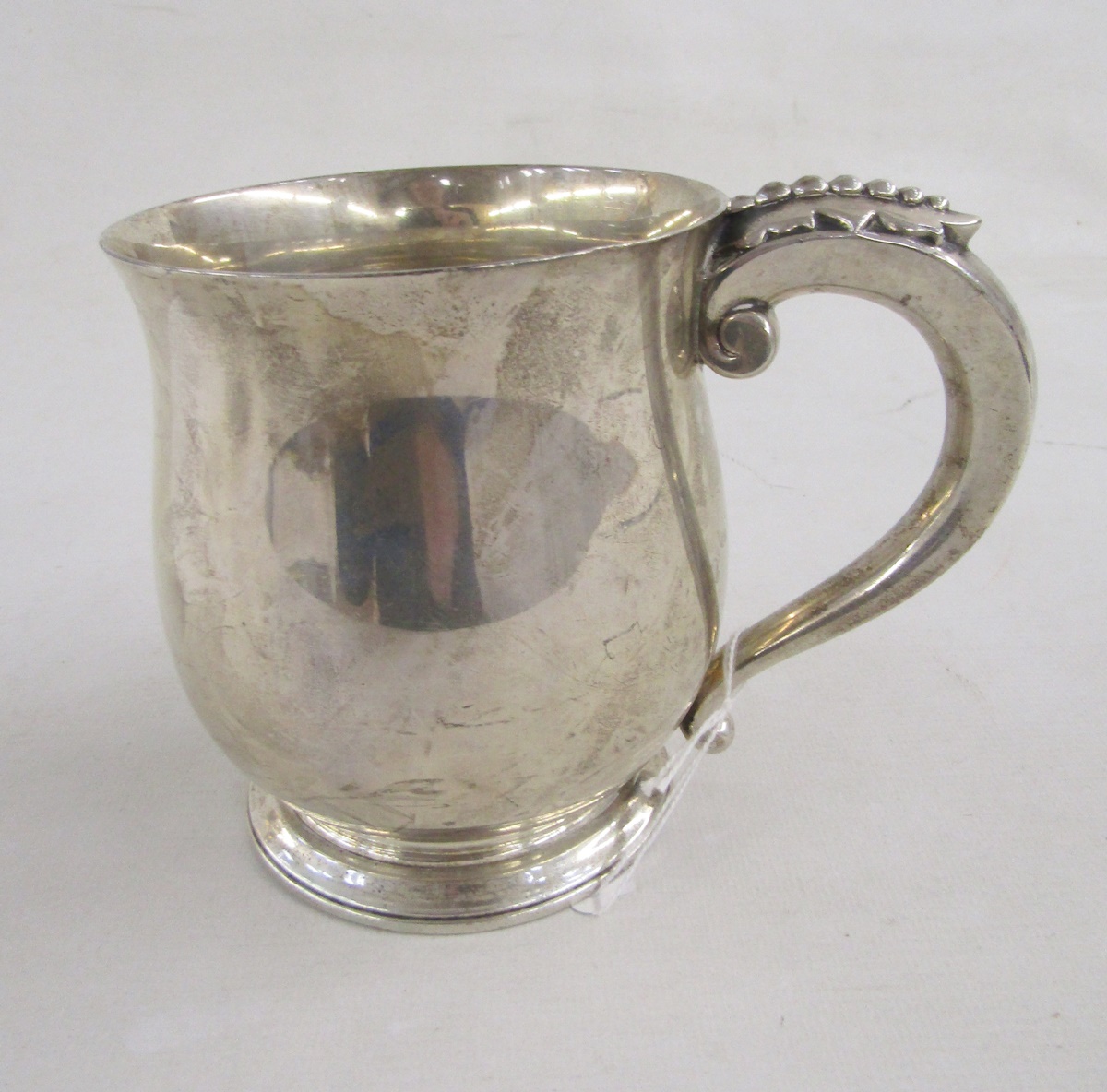 George V silver baluster mug by Asprey & Co, with leaf finial to the handle, engraved initial to
