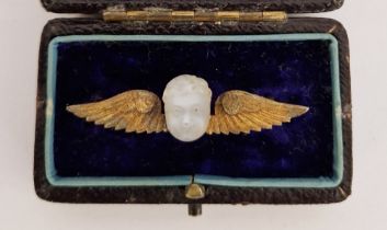 Gilt metal and carved moonstone cherub's head and wings brooch in original leather, velvet and