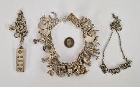 Silver charm bracelet with numerous charms, a silver ingot, and a silver Rennie Mackintosh-style