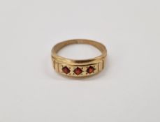 9ct gold and ruby ring, gypsy set three circular stones size X, gross weight 3.4g