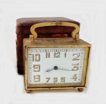 Art Deco brass-mounted travelling clock in original brown leather case, of rectangular section,