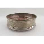 Silver and stained wood wine bottle coaster, London 1997, and a silver-plate wine coaster with