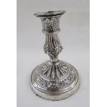 White metal single candlestick, with embossed acanthus leaf and scallop shell decoration,