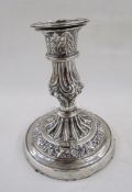 White metal single candlestick, with embossed acanthus leaf and scallop shell decoration,