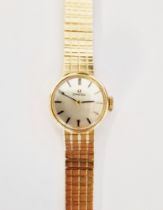Vintage lady's 9ct gold Omega wristwatch, the circular silvered dial having baton hour markers,