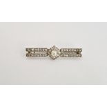 Diamond and pearl bar brooch set numerous tiny diamonds in twin bars and centred by single